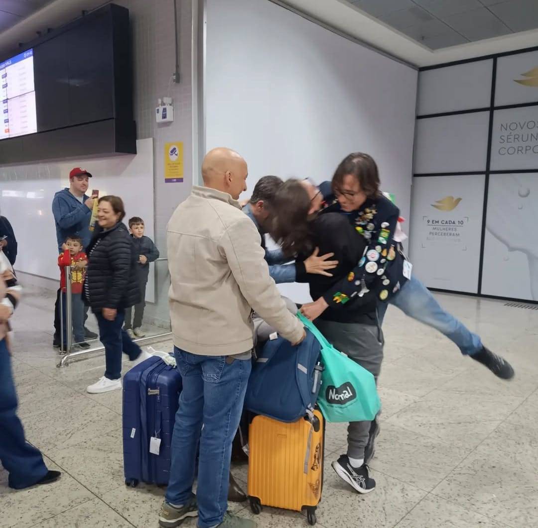 João e seus pais no aeroporto
